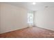 Empty bedroom showcasing plush carpeting and a bright window at 3627 Alexander Forest Dr, Charlotte, NC 28269