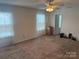 Bedroom with a ceiling fan, carpeting, and natural light, offering a comfortable living space at 3627 Alexander Forest Dr, Charlotte, NC 28269