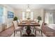 Staged dining room featuring a large wooden table with seating for six and an ornate hanging light fixture at 3627 Alexander Forest Dr, Charlotte, NC 28269