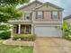 Charming two-story home with a two-car garage, neutral siding, and eye-catching red shutters at 3627 Alexander Forest Dr, Charlotte, NC 28269