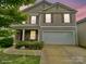 Charming two-story home with a two-car garage, neutral siding, and eye-catching red shutters at 3627 Alexander Forest Dr, Charlotte, NC 28269