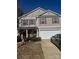 Inviting two-story home featuring tan siding, brick accents, and a convenient two-car garage at 3627 Alexander Forest Dr, Charlotte, NC 28269