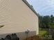 Home's exterior showing light siding and a garden visible in the yard at 3627 Alexander Forest Dr, Charlotte, NC 28269