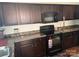 Kitchen showcasing dark cabinetry, modern black appliances and laminate counters at 3627 Alexander Forest Dr, Charlotte, NC 28269