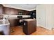 This kitchen features dark cabinetry, modern appliances, an island and durable countertops at 3627 Alexander Forest Dr, Charlotte, NC 28269