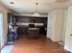 Open kitchen includes dark wood cabinetry, a central island and modern appliances at 3627 Alexander Forest Dr, Charlotte, NC 28269