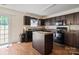 A functional kitchen features dark cabinetry, modern appliances, and a central island with durable countertops at 3627 Alexander Forest Dr, Charlotte, NC 28269
