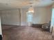 Living room features a vintage chandelier and neutral carpet at 3627 Alexander Forest Dr, Charlotte, NC 28269