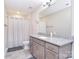 Stylish bathroom featuring granite countertops, modern fixtures, and a shower-tub combo at 4017 Avis Way, Monroe, NC 28110