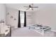 Cozy bedroom featuring carpeted floors, ceiling fan, curtains, and ample natural light at 4017 Avis Way, Monroe, NC 28110