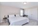 Bright bedroom with carpet, a double bed, and closet with white doors; great natural light from a window at 4017 Avis Way, Monroe, NC 28110