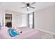 Bright bedroom with ceiling fan, neutral walls, carpet, and a lovely bed set at 4017 Avis Way, Monroe, NC 28110