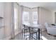 Bright dining area with wood floors, table, and chairs next to three large, light-filled windows at 4017 Avis Way, Monroe, NC 28110