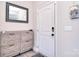 Bright foyer with white door, gray accents, stylish wooden cabinet, and modern mirror at 4017 Avis Way, Monroe, NC 28110