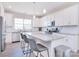 Modern kitchen with white cabinetry, island with bar seating, and stainless steel appliances at 4017 Avis Way, Monroe, NC 28110