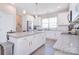 Open kitchen featuring an island with granite countertops, white cabinets, and stainless appliances at 4017 Avis Way, Monroe, NC 28110