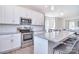 Bright kitchen with white cabinets, stainless steel appliances, granite countertops, and center island at 4017 Avis Way, Monroe, NC 28110