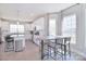 Open concept kitchen with white cabinets, stainless steel appliances, and a wooden dining table at 4017 Avis Way, Monroe, NC 28110