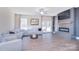 Spacious living room featuring a modern fireplace, large TV, and comfortable seating area at 4017 Avis Way, Monroe, NC 28110