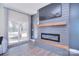 Contemporary living room with stylish fireplace, TV, and sliding doors leading to outdoor space at 4017 Avis Way, Monroe, NC 28110