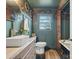 Stylish bathroom featuring a clawfoot tub, wood accents, hexagon tile and unique wallpaper at 5622 S Rocky River Rd, Monroe, NC 28112