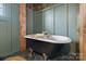 Stylish bathtub featuring a clawfoot tub, and views from the window at 5622 S Rocky River Rd, Monroe, NC 28112