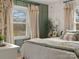 Bright bedroom offering a comfortable space and serene view from the large windows at 5622 S Rocky River Rd, Monroe, NC 28112