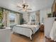 Cozy bedroom featuring neutral tones, soft textures, and ample natural light from the windows at 5622 S Rocky River Rd, Monroe, NC 28112