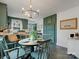 Bright dining area with stylish lighting fixture and open access to the modern kitchen at 5622 S Rocky River Rd, Monroe, NC 28112