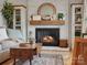 Charming fireplace with a brick surround, wooden mantle, and decorative accents at 5622 S Rocky River Rd, Monroe, NC 28112