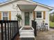 Inviting front entrance with white brick, wooden shutters, and bistro table at 5622 S Rocky River Rd, Monroe, NC 28112