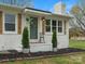 Inviting front entrance with white brick, wooden shutters, and well-manicured landscaping at 5622 S Rocky River Rd, Monroe, NC 28112