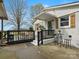 Charming porch with black railing, bistro table, and front door at 5622 S Rocky River Rd, Monroe, NC 28112