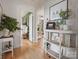 A hallway featuring hardwood floors and views into other rooms, enhancing the home's open and inviting layout at 5622 S Rocky River Rd, Monroe, NC 28112