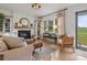 Bright living room featuring a white brick fireplace, hardwood floors, and a cozy seating area at 5622 S Rocky River Rd, Monroe, NC 28112