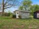 Small shed made of grey blocks, with a single door and surrounded by grass at 5622 S Rocky River Rd, Monroe, NC 28112