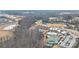 Aerial shot of a community including a clubhouse, swimming pool, tennis courts, and pond at 7336 Overjoyed Xing, Charlotte, NC 28215