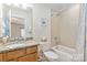 Cozy bathroom with a granite vanity, a bath tub with a shower, neutral paint and tile at 7336 Overjoyed Xing, Charlotte, NC 28215