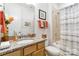 Well lit bathroom with granite vanity, a bath tub with shower and decorative accents at 7336 Overjoyed Xing, Charlotte, NC 28215