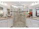 Modern bathroom featuring a glass-enclosed shower, double vanity, and granite countertops, blending style and functionality at 7336 Overjoyed Xing, Charlotte, NC 28215