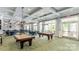 Spacious community billiards room with tables, ample seating, and lots of light at 7336 Overjoyed Xing, Charlotte, NC 28215