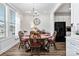 Cozy dining room features a round wooden table, chairs, and a stylish chandelier above at 7336 Overjoyed Xing, Charlotte, NC 28215