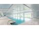 Beautiful indoor pool with bright interior, ample windows and a full-size pool at 7336 Overjoyed Xing, Charlotte, NC 28215