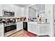 Bright kitchen showcases white cabinets, granite countertops, stainless steel appliances, and farmhouse sink at 7336 Overjoyed Xing, Charlotte, NC 28215