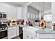 Charming kitchen boasts white cabinetry, granite countertops, stainless steel appliances, and stylish decor at 7336 Overjoyed Xing, Charlotte, NC 28215