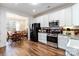 Kitchen offers stainless steel appliances, granite countertops, white cabinetry, and a breakfast nook at 7336 Overjoyed Xing, Charlotte, NC 28215