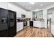 Well-lit kitchen offers stainless steel appliances, white cabinets, granite counters and modern fixtures at 7336 Overjoyed Xing, Charlotte, NC 28215