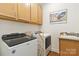 Functional laundry room with modern appliances, cabinets, countertops and a sink at 7336 Overjoyed Xing, Charlotte, NC 28215
