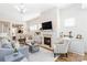 Bright living room with an open layout and inviting atmosphere, featuring a fireplace and seamless dining room access at 7336 Overjoyed Xing, Charlotte, NC 28215