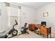Bright office space with natural light, a desk with chair, an exercise bike, and neutral walls and carpet at 7336 Overjoyed Xing, Charlotte, NC 28215